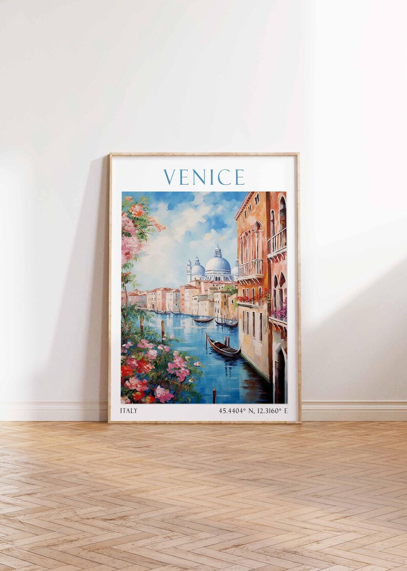May include: Framed art print of Venice, Italy, featuring a canal scene with buildings, boats, and floral accents. The word "VENICE" is at the top, with "ITALY" and coordinates at the bottom. The artwork is in a wooden frame.