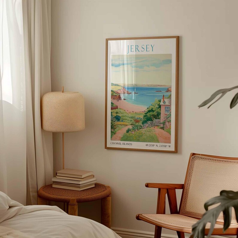 May include: A framed poster depicting a coastal scene, with the word "JERSEY" at the top. The poster includes the text "CHANNEL ISLANDS" and coordinates at the bottom. The frame is a light brown colour. The image is reminiscent of a vintage travel poster.