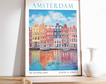 May include: A colorful poster with a painting of a row of colorful houses along a canal in Amsterdam, The Netherlands. The poster has the text "AMSTERDAM" at the top and "THE NETHERLANDS 52.3676° N, 4.9041° E" at the bottom.
