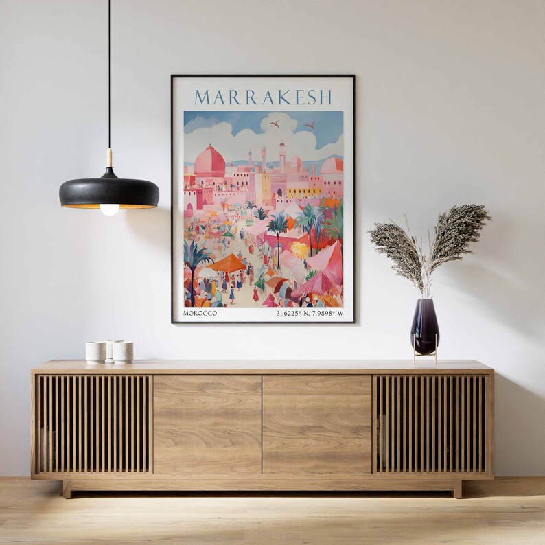 May include: A vintage travel poster featuring a colorful illustration of the city of Marrakesh, Morocco. The poster includes the text "MARRAKESH" in a bold font and the coordinates "31.6225&deg; N, 7.9888&deg; W".