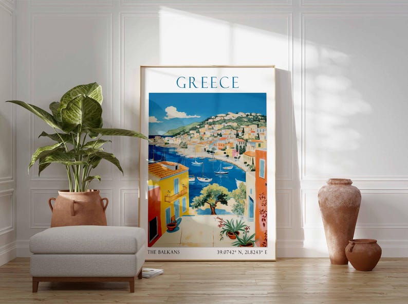 May include: A vintage travel poster featuring a colorful illustration of a coastal town in Greece. The poster has the text "GREECE" in large blue letters at the top and "THE BALKANS" and coordinates at the bottom.