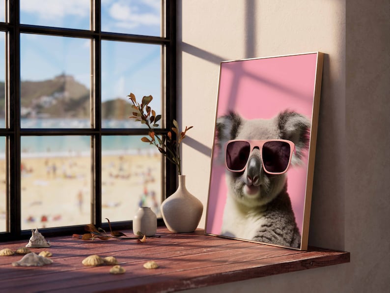 May include: A framed print of a koala wearing pink sunglasses against a pink background. The koala is looking directly at the camera with a relaxed expression.
