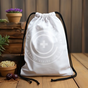 May include: White drawstring bag with black drawstrings. The bag has a white circle logo with a plus sign in the center and the text "Mock Factory Quality Styled Images".