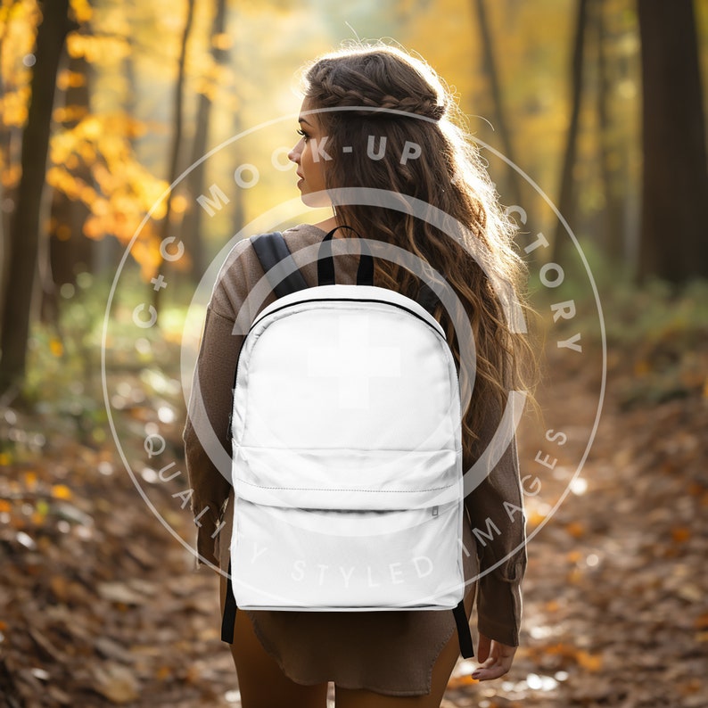 A Woman walking through a forest wearing a blank white backpack. A Mock-up image of a Unisex Classic Backpack sold at Printify as POD. This image is perfect to sell your Backpack bag design. Just add your designed bag image in.