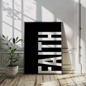 May include: Black and white poster with the word "FAITH" printed in white letters on a black background.