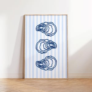 May include: A framed print with a blue and white striped background and three blue oyster illustrations.