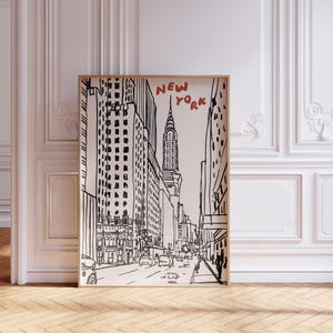 May include: Black and white line drawing of a New York City street scene with skyscrapers, including the Empire State Building, and the text "NEW YORK" in red and black.