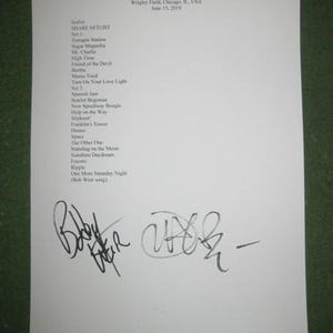 May include: A white sheet of paper with a Dead & Company setlist from Wrigley Field, Chicago, IL, USA, June 15, 2019. The setlist includes songs like "Sugar Magnolia" and "Ripple", and is signed by Bobby Weir.