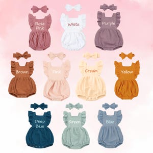 May include: A collection of baby rompers in various colors, each paired with a matching bow headband. Colors include rose pink, white, purple, brown, pink, cream, yellow, deep blue, green, and blue. Each romper has ruffled sleeves and the color name is printed on the front.