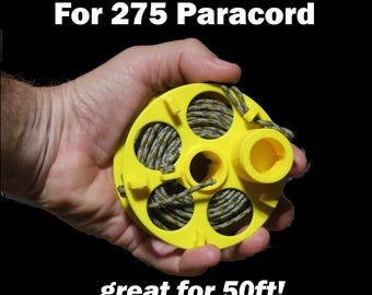 May include: A bright yellow plastic spool designed for 275 paracord, featuring a circular frame with five open sections for winding cord. The text "For 275 Paracord" and "great for 50ft!" is printed in white against the black background.