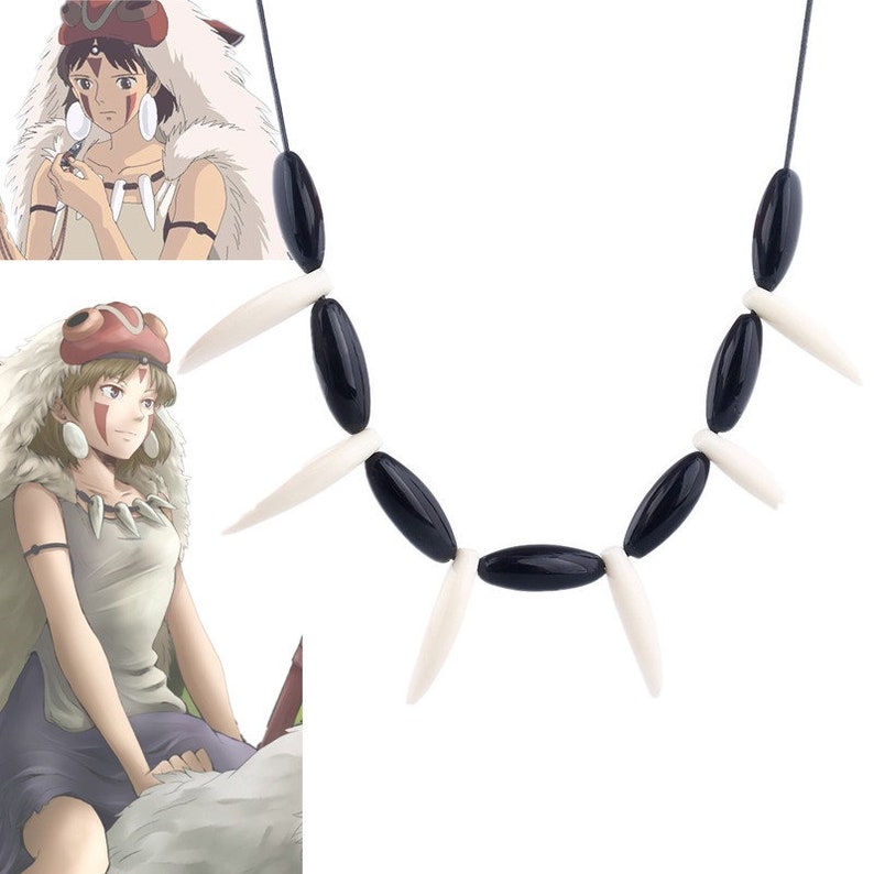 May include: A black and white beaded necklace with a pendant shaped like a wolf's tooth. The necklace is made of oval-shaped black beads and white beads that are shaped like fangs.