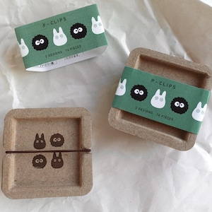 May include: Two cardboard boxes with green and white labels that say "P-Clips" and feature cartoon characters. The boxes contain 14 and 16 paper clips.