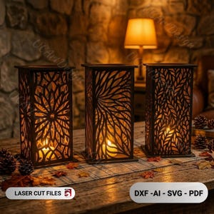 May include: Three rectangular dark brown laser-cut wooden lanterns with intricate floral and leaf patterns. Each lantern contains a glowing light source inside, casting shadows through the cutouts. The text LASER CUT FILES and DXF-AI-SVG-PDF is visible.