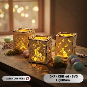 May include: Three wooden Easter-themed lanterns with intricate laser-cut designs of bunnies, eggs, and trees. The lanterns are illuminated from within, casting a warm glow. Decorative Easter eggs and greenery surround the lanterns. The text "LASER CUT FILES" and "DXF - CDR -AI - SVG LightBurn" are visible.