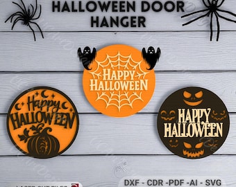 May include: Halloween door hanger set with three circular designs. One features a pumpkin, another a spiderweb with ghosts, and the third a jack-o'-lantern face. The words "Happy Halloween" are displayed on each. Includes laser cut files.