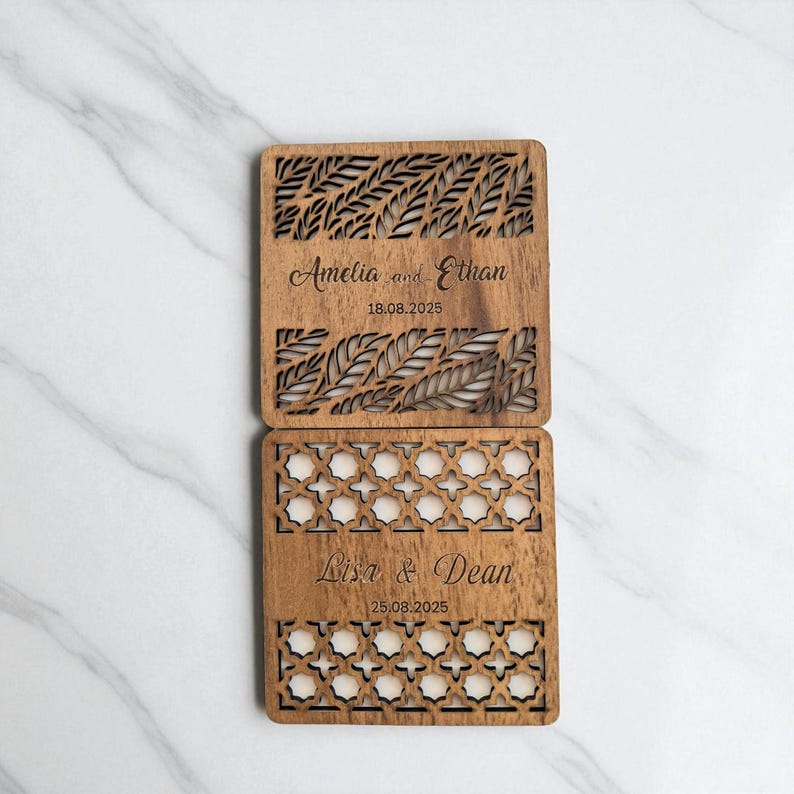 May include: Two wooden coasters with intricate laser-cut designs. The top coaster features a leaf pattern and the names "Amelia and Ethan" with the date "18.08.2025". The bottom coaster has a geometric pattern and the names "Lisa & Dean" with the date "25.08.2025".
