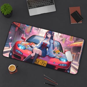 May include: A rectangular mousepad featuring a red sports car with a woman in anime style sitting on the hood. The background depicts a Japanese street scene with cherry blossoms. The mousepad has a black border and a white mouse.