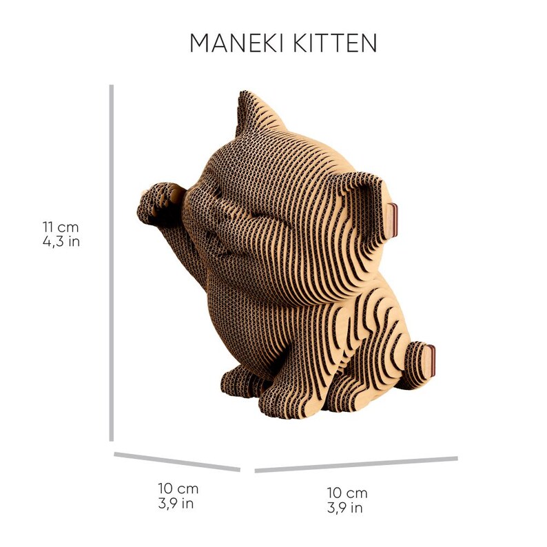 May include: A Maneki Kitten figurine constructed from layered tan corrugated cardboard. The cat is in a seated position with one paw raised. Dimensions are 11 cm in height, 10 cm in width, and 10 cm in depth as indicated by the text in the image.