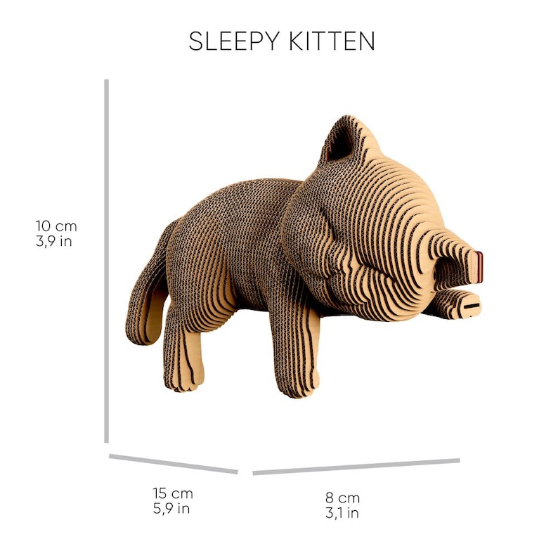 May include: A layered cardboard sculpture of a kitten labelled SLEEPY KITTEN. The figure measures 10 cm in height, 15 cm in length, and 8 cm in width, featuring a tan, ribbed texture created by stacked corrugated cardboard layers.
