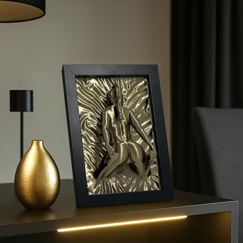 Gold erotic wall art sculpture of a naked woman in black frame