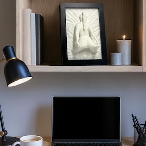 White erotic art sculpture naked woman on desk with lamp and laptop