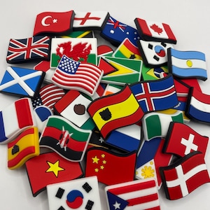 May include: A collection of colourful, small, rubber flag charms. The flags represent different countries around the world, including the United Kingdom, Canada, Mexico, China, Japan, and many more.