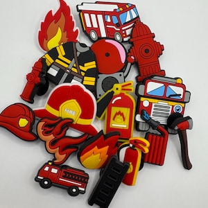 May include: A collection of red, yellow and black firefighter themed shoe charms. The charms include a fire engine, a fireman, a fire hydrant, a fire extinguisher, a ladder and flames.