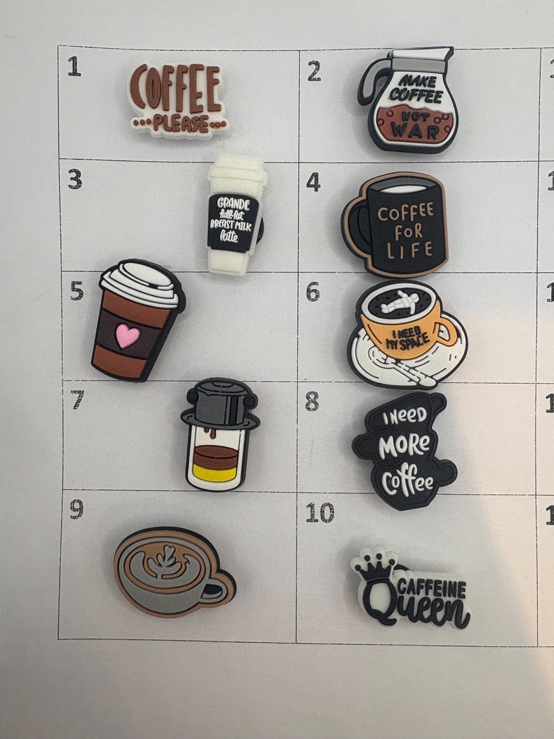 May include: A collection of coffee-themed charms with various designs and text. Includes a coffee pot, a coffee cup with "Coffee for Life", a coffee cup with "I need my space", and a charm that says "Caffeine Queen".