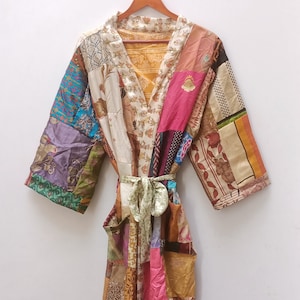 May include: A long, patchwork robe with a colourful, floral pattern. The robe has a sash tie and is made of silk.