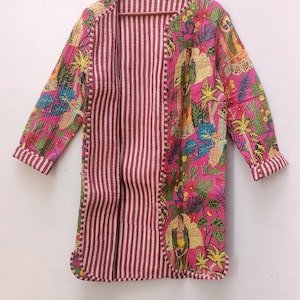 May include: A long, pink and red striped quilted jacket with a floral print on one side. The jacket has a button closure and long sleeves.