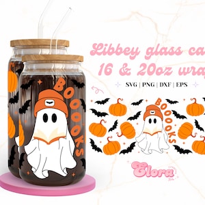 May include: A set of two clear glass jars with lids and straws. The jars are decorated with a ghost wearing a beanie and holding a book. The text "BOO-OOKS" is on the jars. The background is a white marble surface.