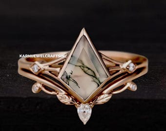 May include: A rose gold engagement ring with a unique, green and white agate gemstone set in a delicate, geometric design. The ring features a delicate, leafy design and small diamonds on the band.