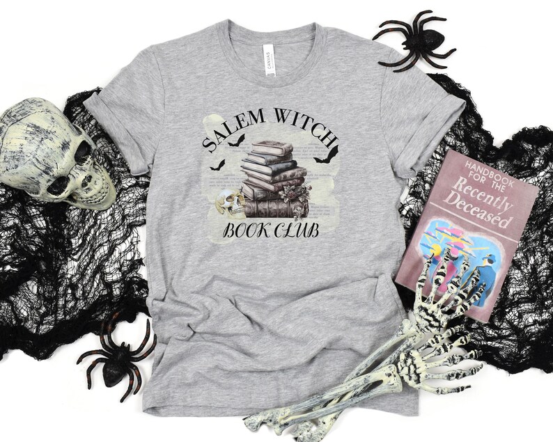 May include: Gray t-shirt with a graphic of a stack of books, bats, and a skull with the text "Salem Witch Book Club".