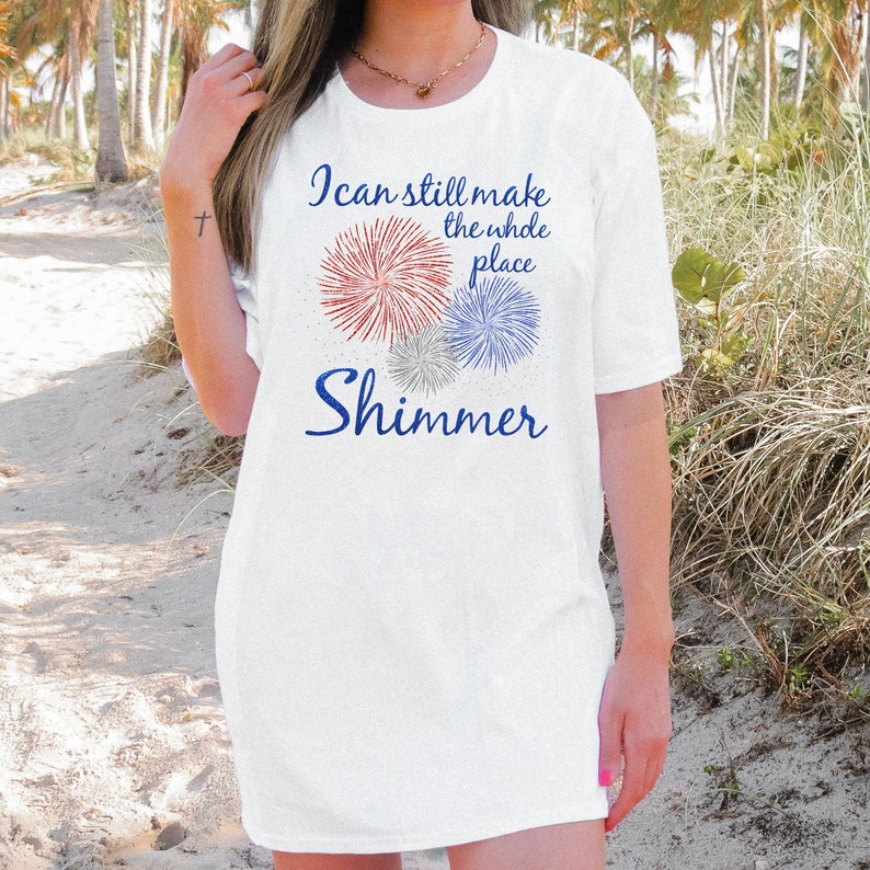 May include: White t-shirt with a graphic of fireworks and the text "I can still make the whole place shimmer."
