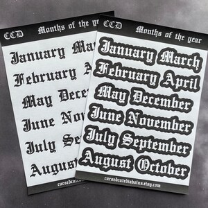May include: Two sheets of white paper with black text. The text is in a gothic font and lists the months of the year. The text on the top sheet reads "CCD Months of the year" and the text on the bottom sheet reads "CCD Months of the year".