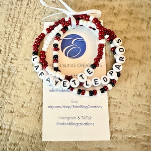 Set of 3 Roanoke beaded bracelets. The first is maroon and white color blocked with Leopards lettering. The second is maroon with white Roanoke lettering. The third is maroon, black and white beads