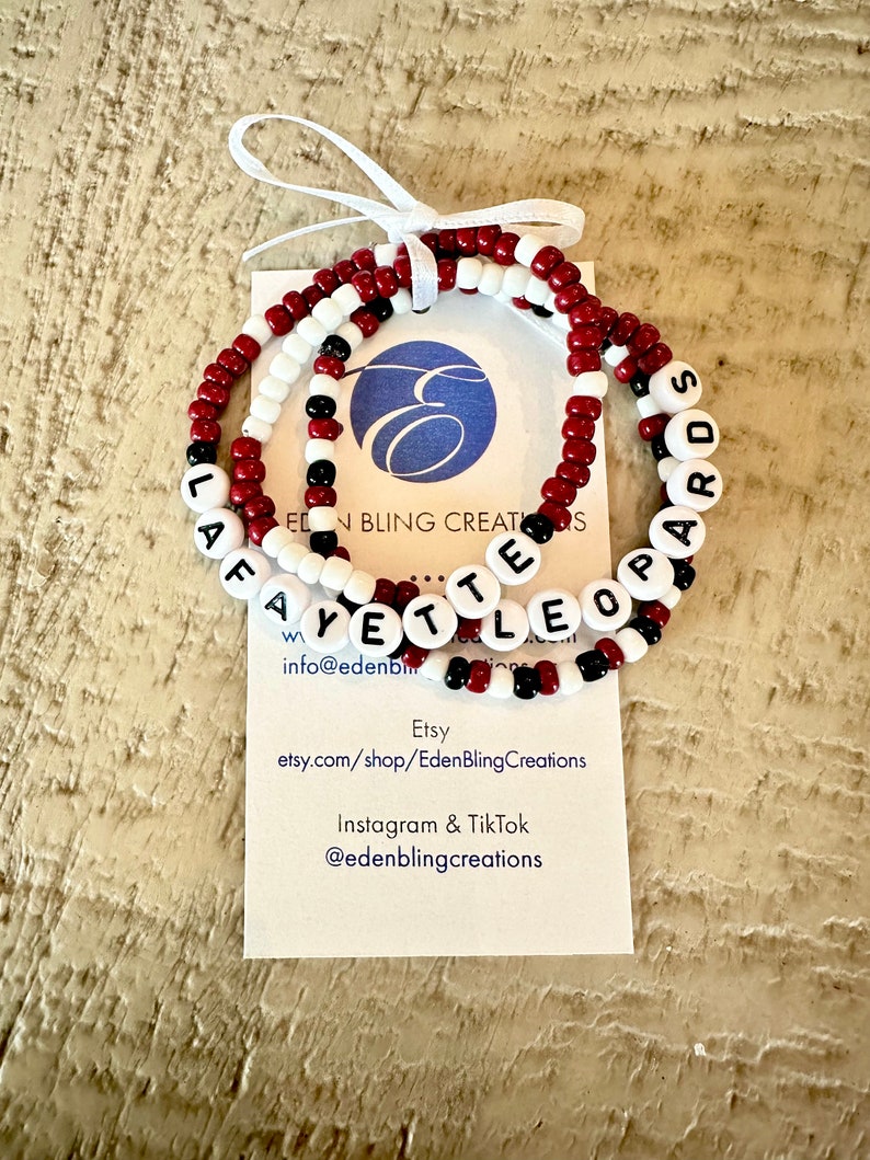 Set of 3 Roanoke beaded bracelets. The first is maroon and white color blocked with Leopards lettering. The second is maroon with white Roanoke lettering. The third is maroon, black and white beads