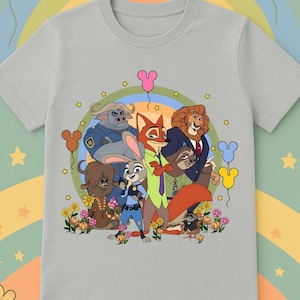 May include: A light gray t-shirt featuring a colorful graphic of characters from the animated movie Zootopia. The design includes Judy Hopps, Nick Wilde, and other characters, with balloons and flowers. The shirt is made of a soft material.