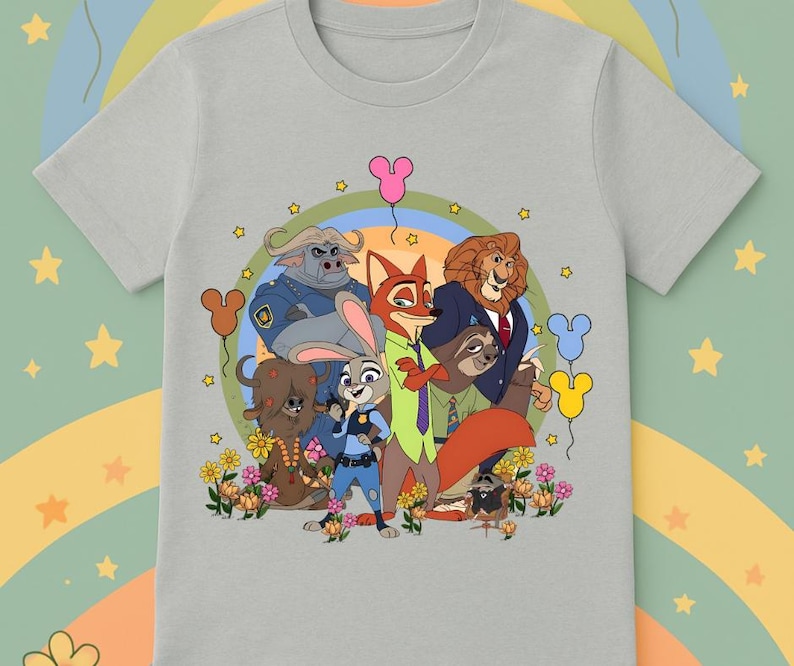 May include: A light gray t-shirt featuring a colorful graphic of characters from the animated movie Zootopia. The design includes Judy Hopps, Nick Wilde, and other characters, with balloons and flowers. The shirt is made of a soft material.