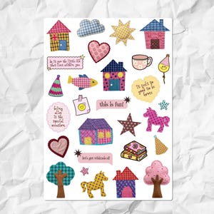 May include: A sticker sheet featuring various illustrations including houses with checkered patterns, a sun, a cloud, hearts, stars, horses, trees, a mug, party hats, and books. Text elements include 'do it for the little kid that lives within you', 'it feels so good to be home', 'this is fun!', 'being alive is the special occasion', and 'let's get whimsical'.