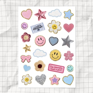 May include: A sticker sheet featuring various embroidered-style patches including pink and blue hearts, yellow smiley faces, stars, flowers, clouds, and bows. Two rectangular patches contain the text "i could be meaner" and "I'm literally just a girl".