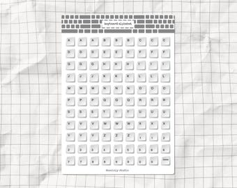 May include: A printable sheet with a keyboard alphabet, numbers, and a delete key. Each key is a white circle with black text. The sheet has a gray brick pattern at the top and the text "keyboard alphabet" in the center.