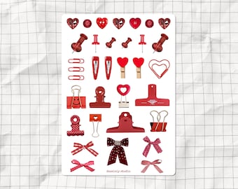 May include: Red and white heart-shaped stickers, red paper clips, red push pins, and red bows. The stickers are in various shapes and sizes. The paper clips are in various sizes. The push pins are in various sizes. The bows are in various sizes. The stickers, paper clips, push pins, and bows are all on a white background. The text "deainily studio" is at the bottom of the image.