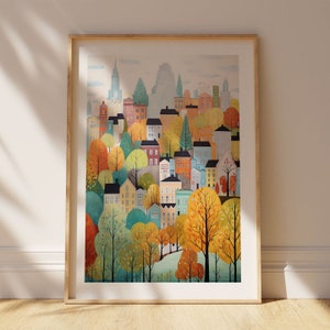 May include: A colorful illustration of a cityscape with buildings and trees in autumn colors. The buildings are mostly yellow, red, and blue, and the trees are mostly orange, yellow, and green. The illustration is framed in a light wood frame.