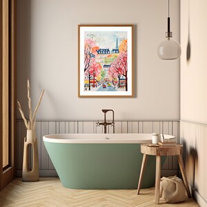 May include: A watercolor painting of a city street scene with pink and white flowering trees, a church steeple in the distance, and cars driving down the street.
