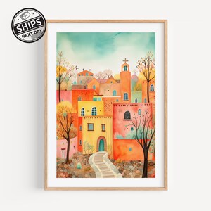 May include: A watercolor painting of a colorful village with a church steeple, surrounded by trees and a stone path leading up to the church.