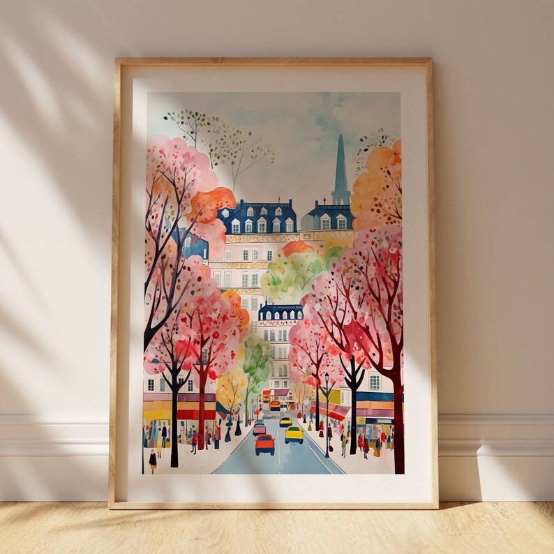 May include: A watercolor painting of a Parisian street scene with pink and white cherry blossom trees lining the street. The buildings are painted in a soft pastel color palette with a blue sky in the background.