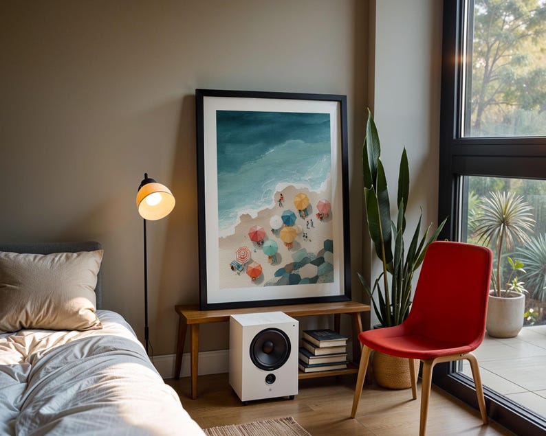 May include: A framed watercolor print of a beach scene with colorful umbrellas hangs above a small wooden bench. A white speaker sits below the print. A red chair and a floor lamp are also in the room.