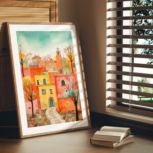 May include: A watercolor painting of a colorful village with a church steeple, surrounded by trees and stone walls. The buildings are painted in shades of orange, yellow, and red, with green accents. The painting has a whimsical and charming style.