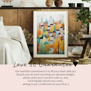 May include: A framed illustration of a city skyline with colorful buildings and trees. The buildings are in a variety of styles and colors, and the trees are in shades of green, yellow, and orange. The text "Love It Guarantee" is below the image with a description of the company's satisfaction guarantee.